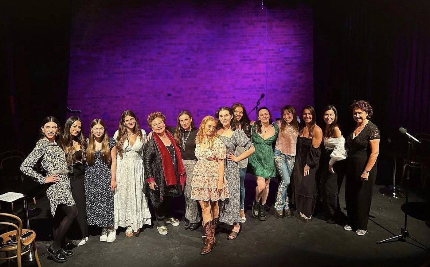 Students and cast on stage at the charity event